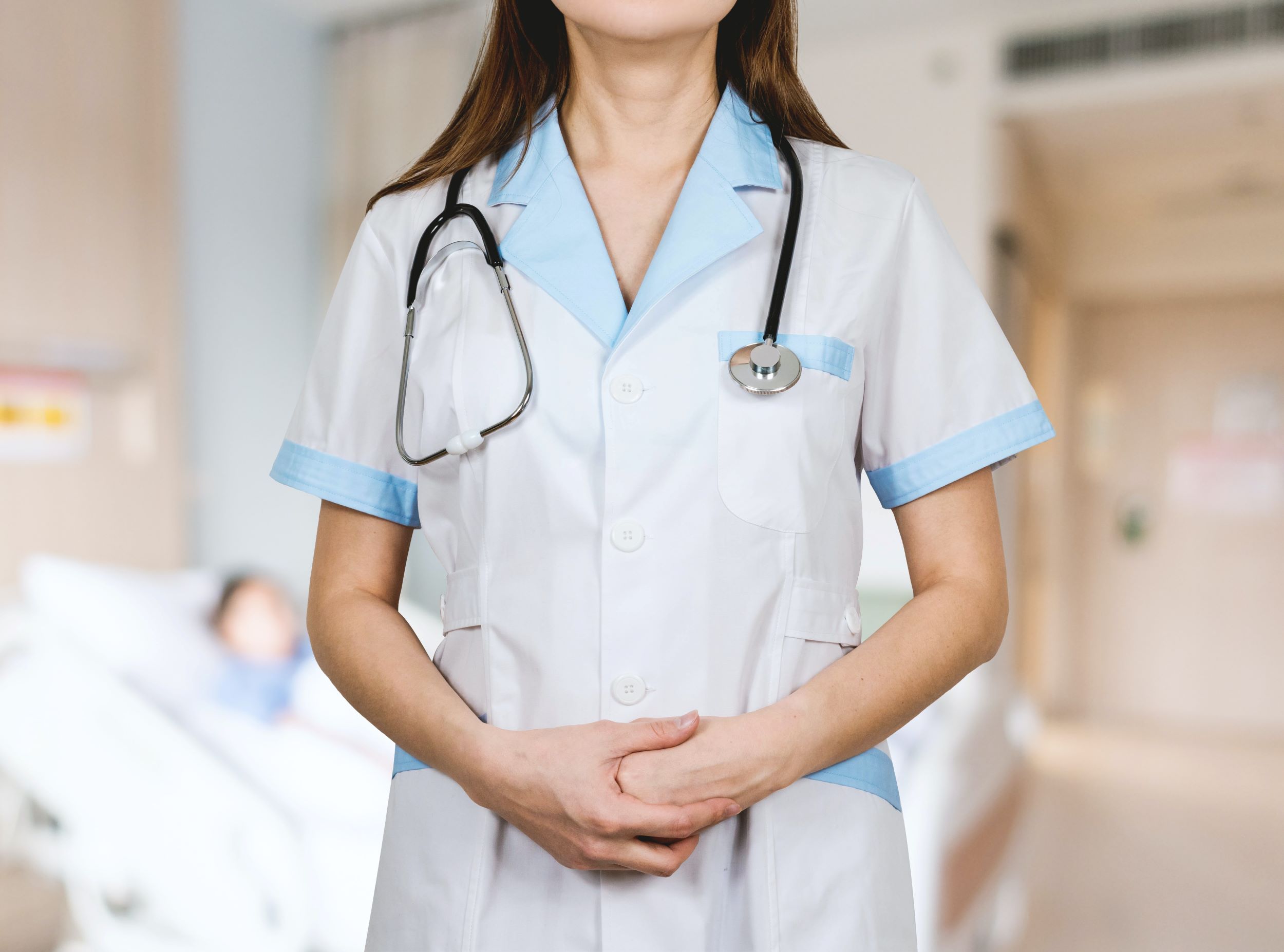 A nurse poses in her uniform.