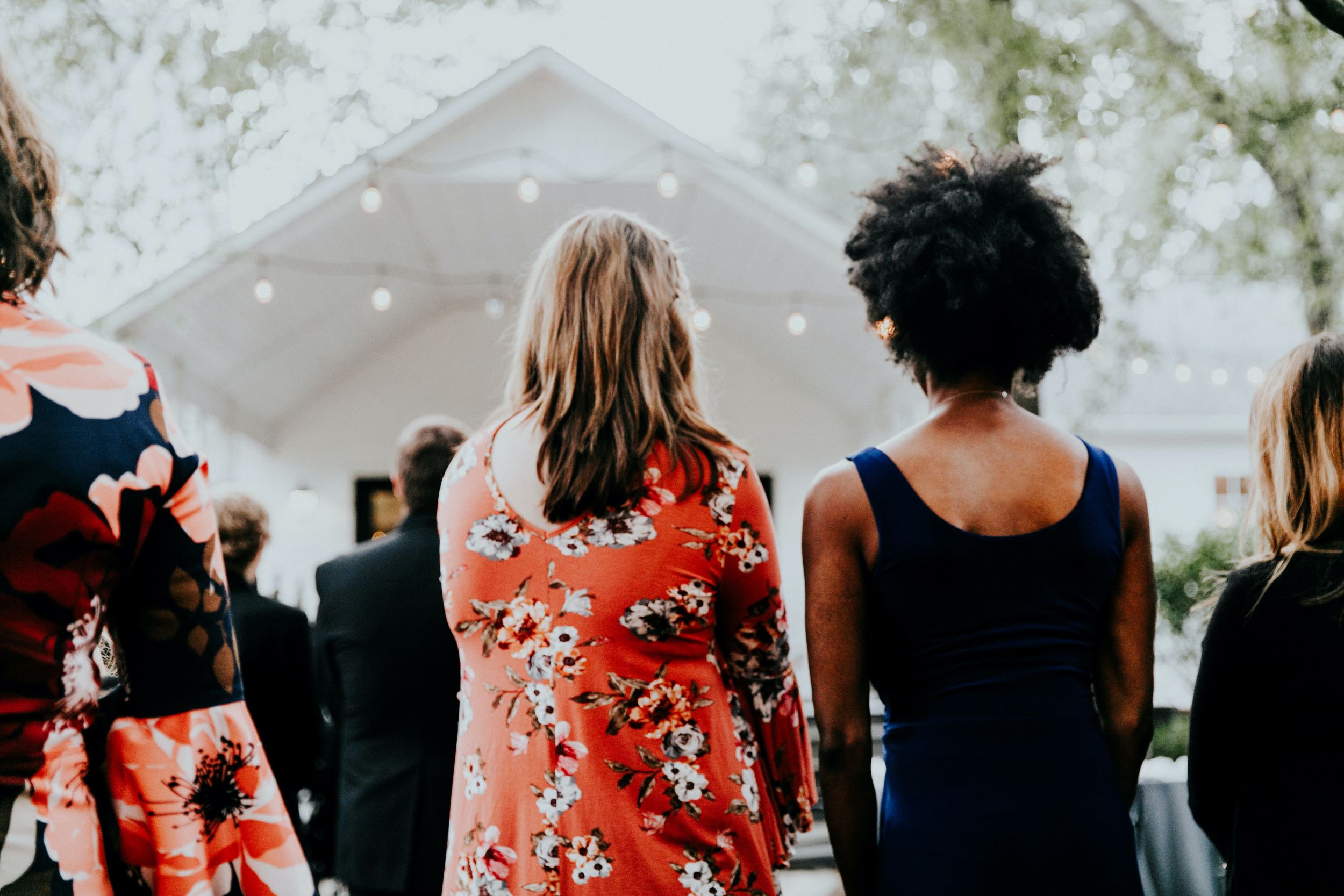 Women stand outside at a rally.