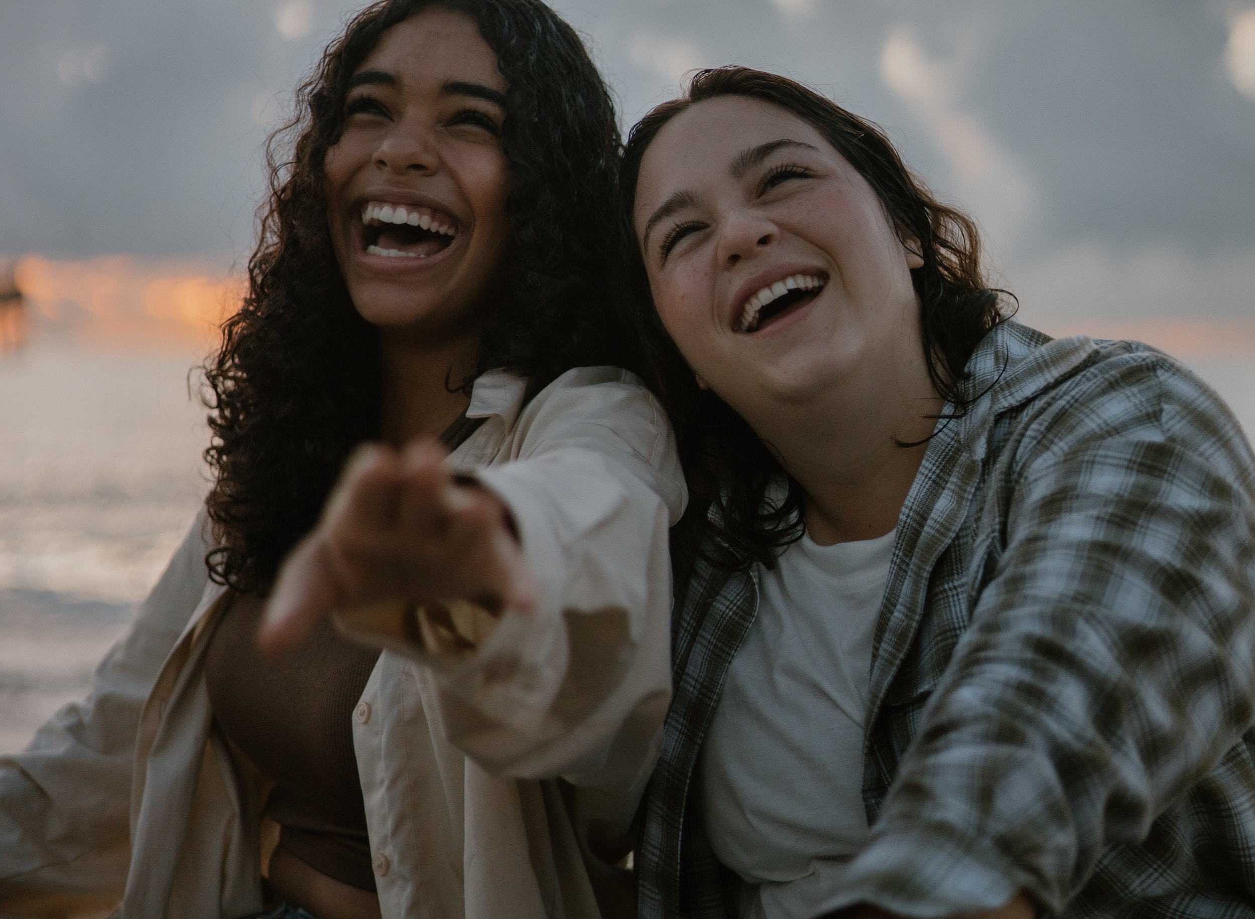 Two teens smile while sitting in a boat.