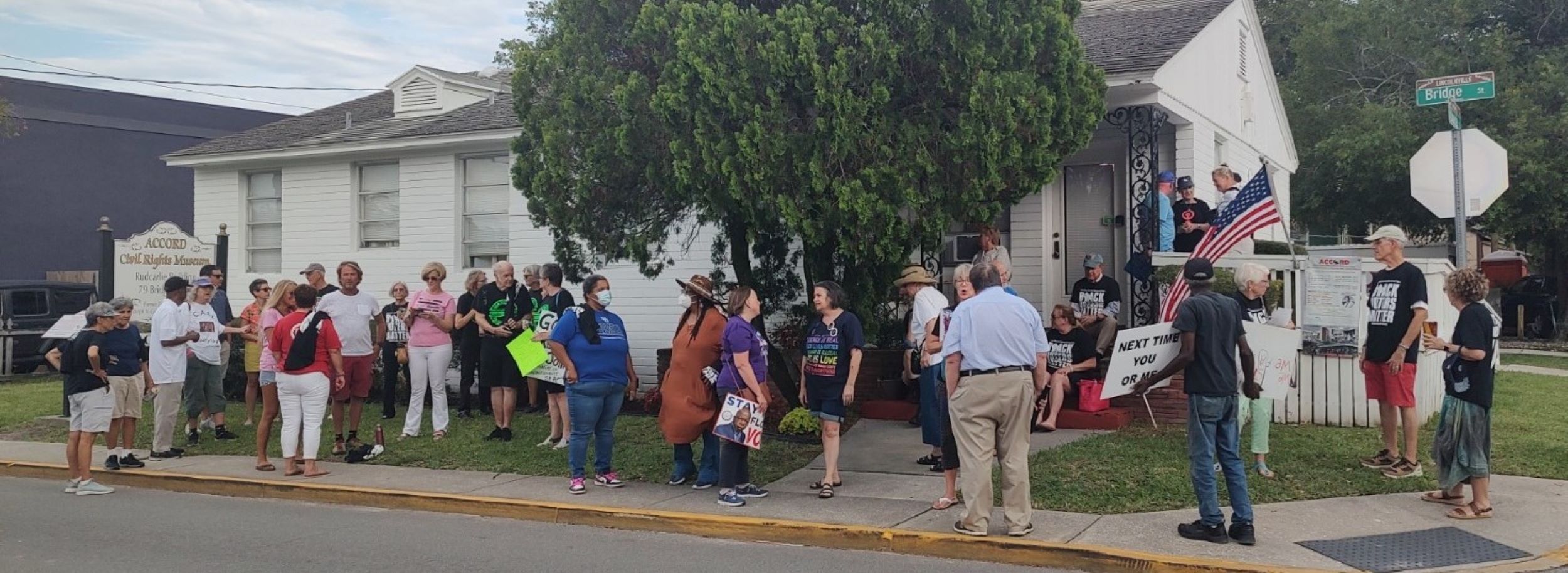 Groups of people crowd in front of the Accord Museum.