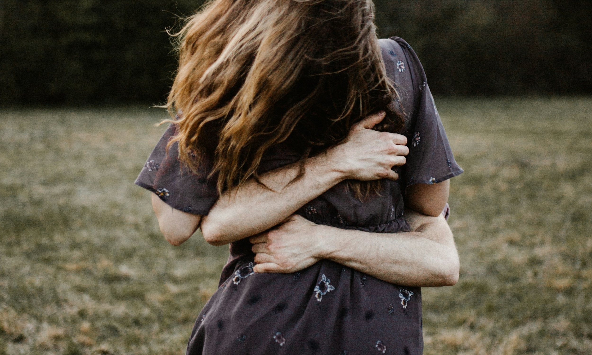 A man and woman embrace each other.
