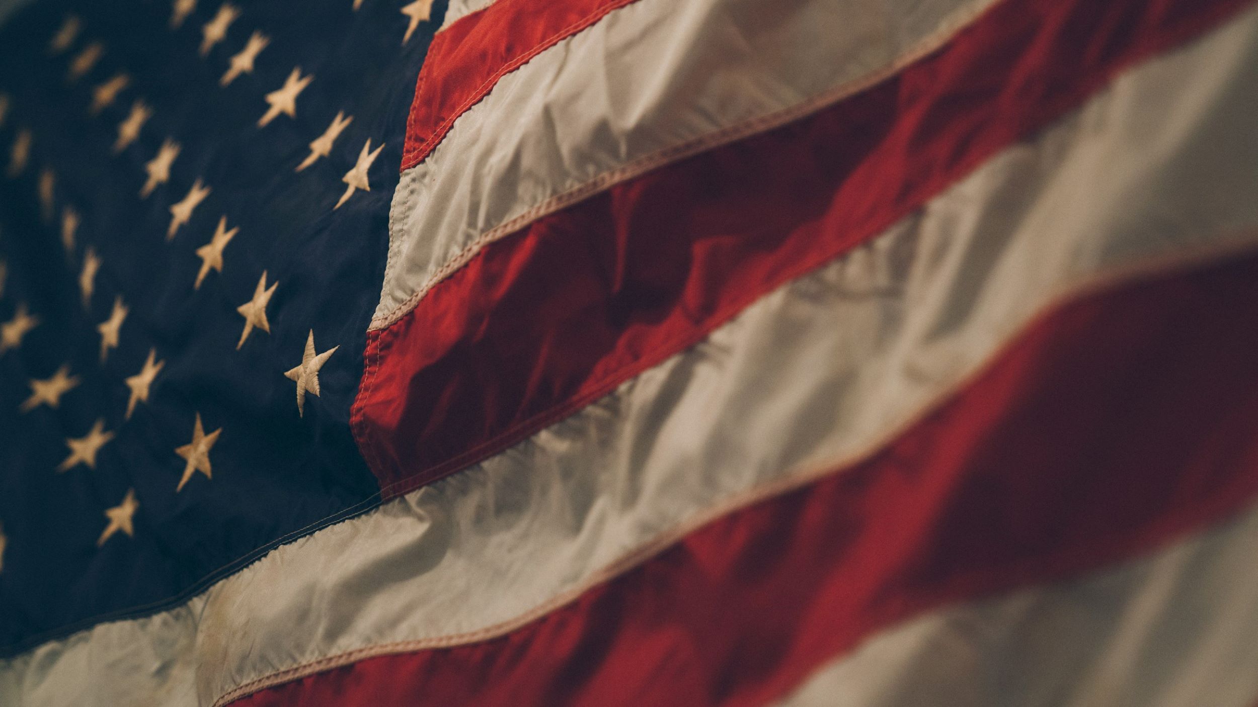 A close up of the American Flag flapping in the wind.