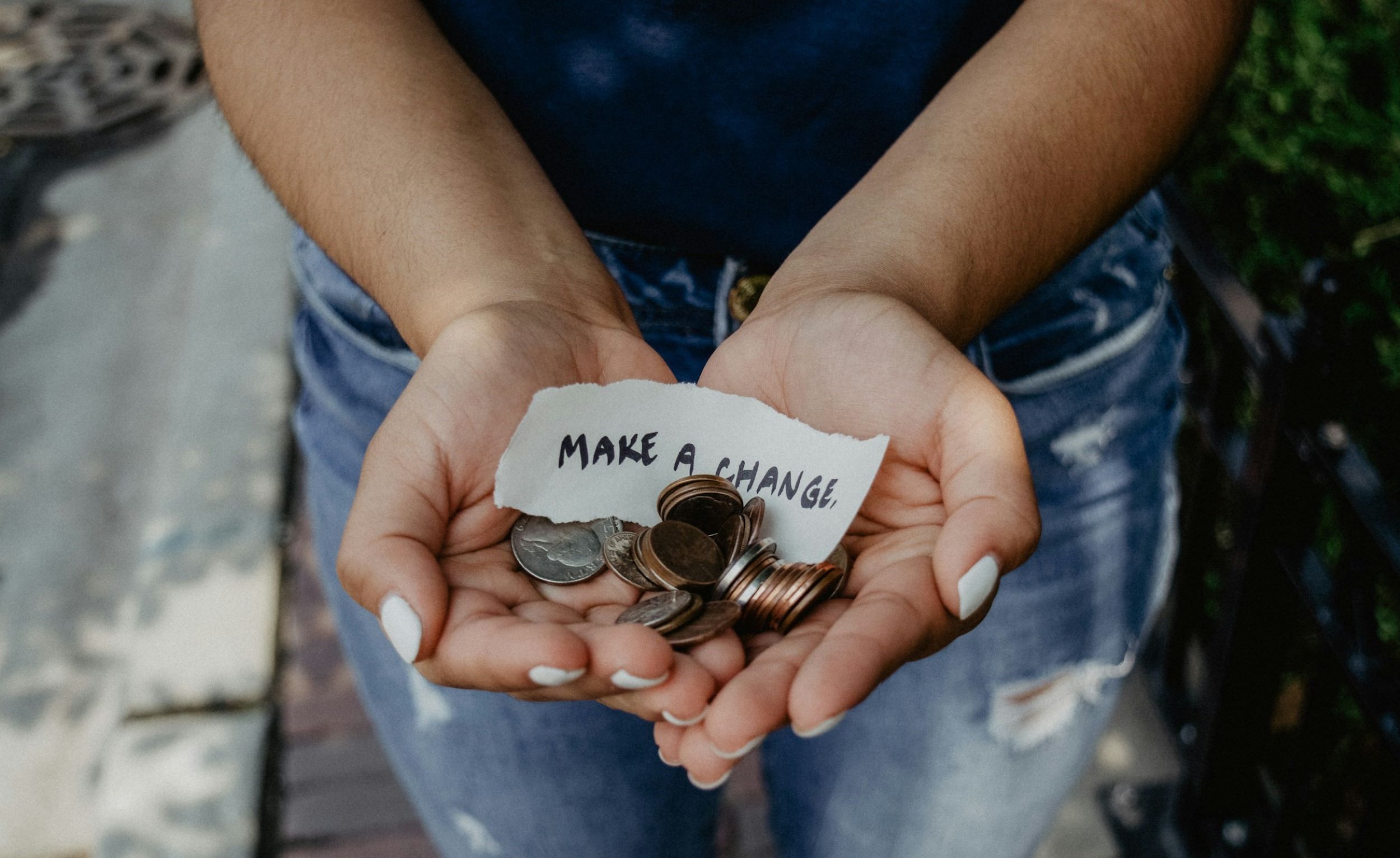 A woman holds coins in her hands.