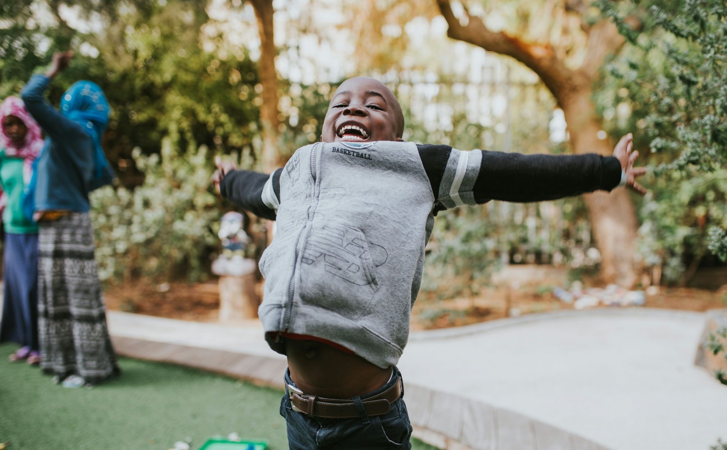 A boy jumps happily in the air.