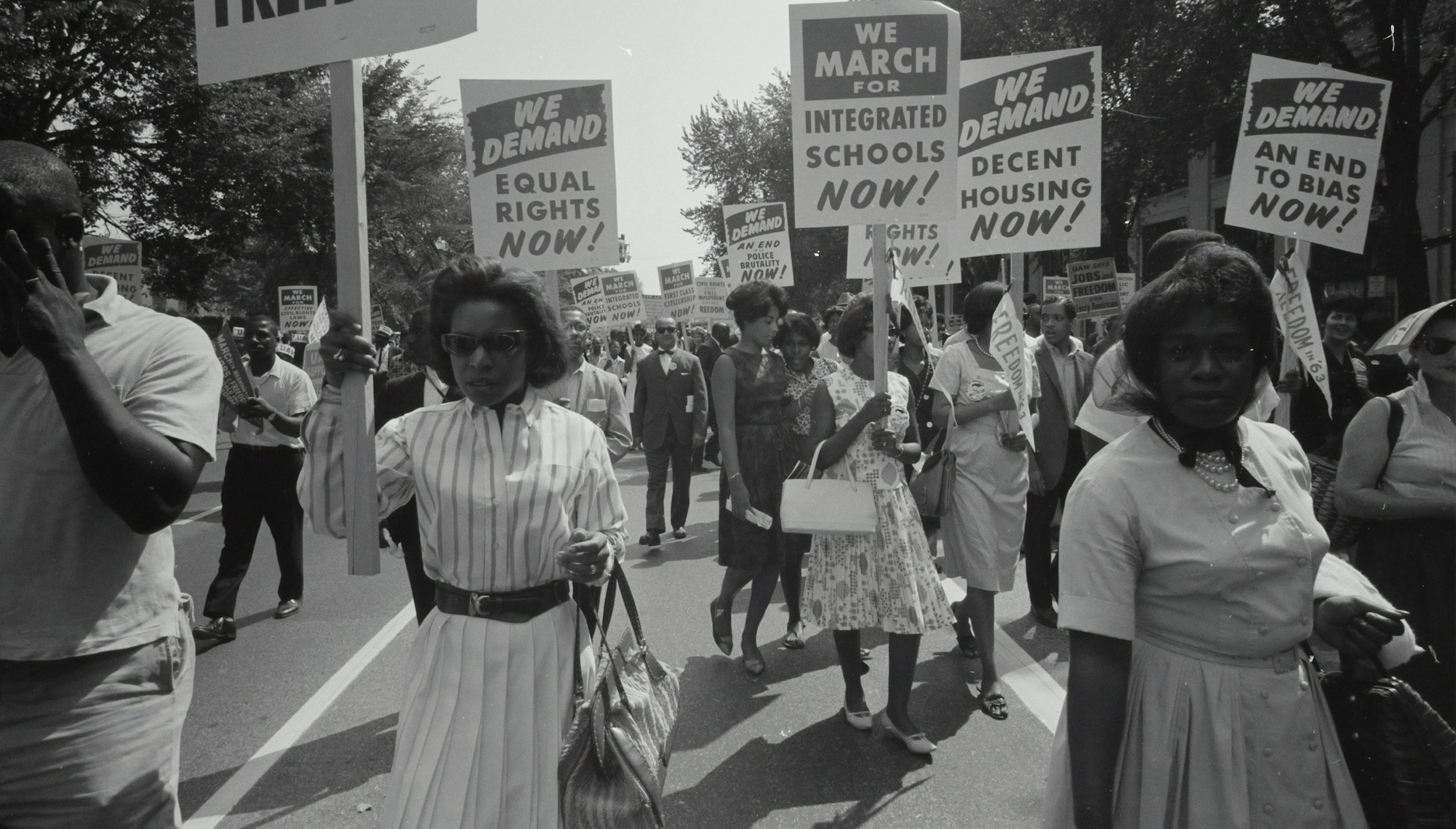 A group of African American men and women protest in the street.
