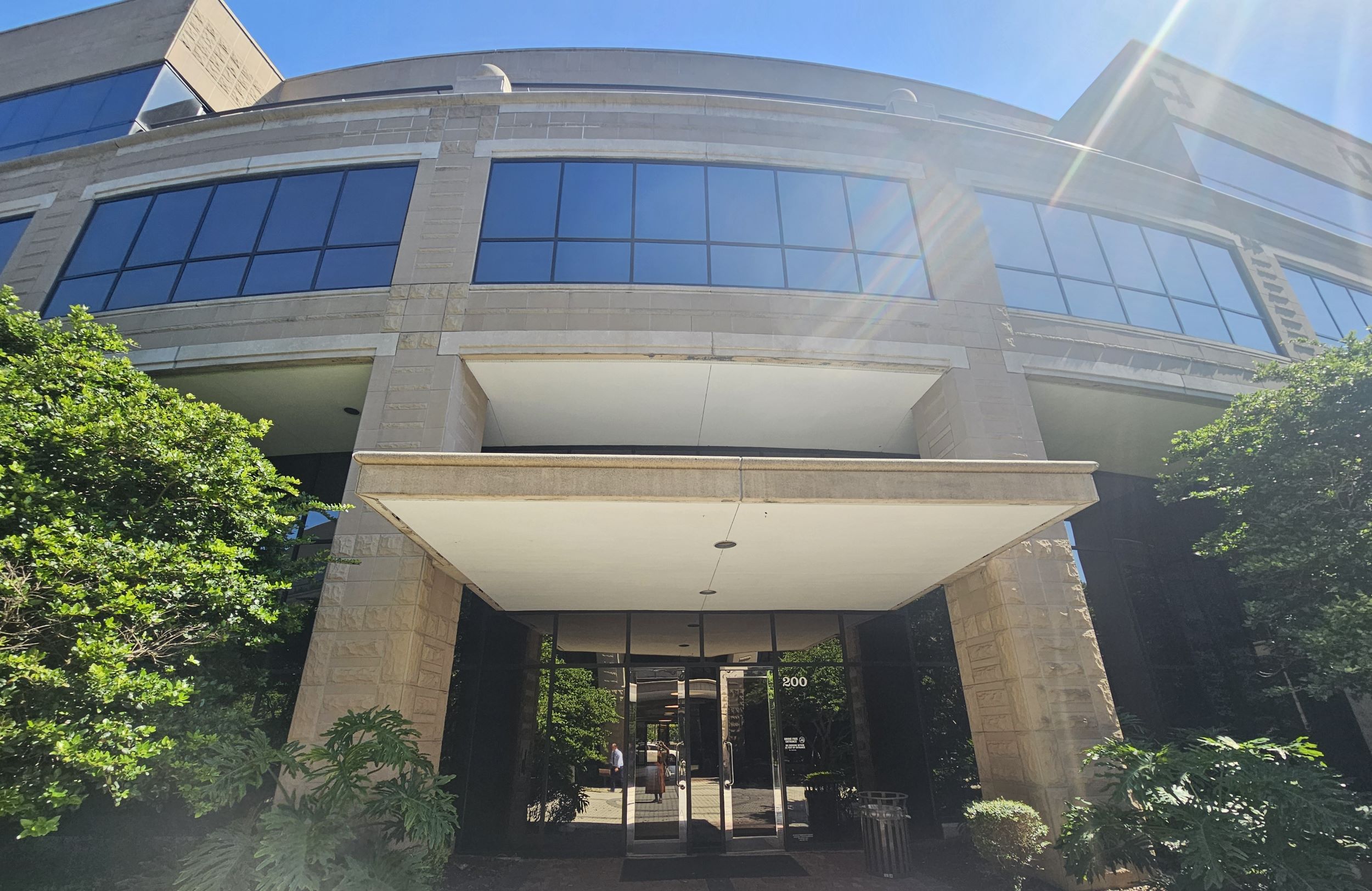 The exterior of the AppleOne building on a sunny day.