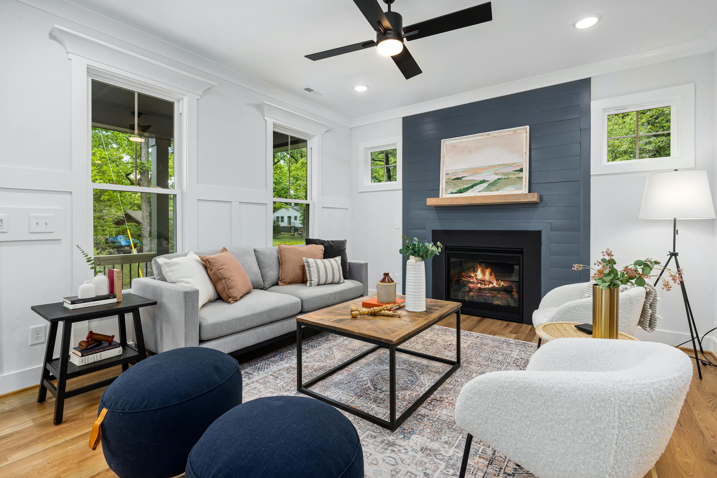 An interior photo of a bright, well-lit room featuring contemporary furniture and a fireplace.