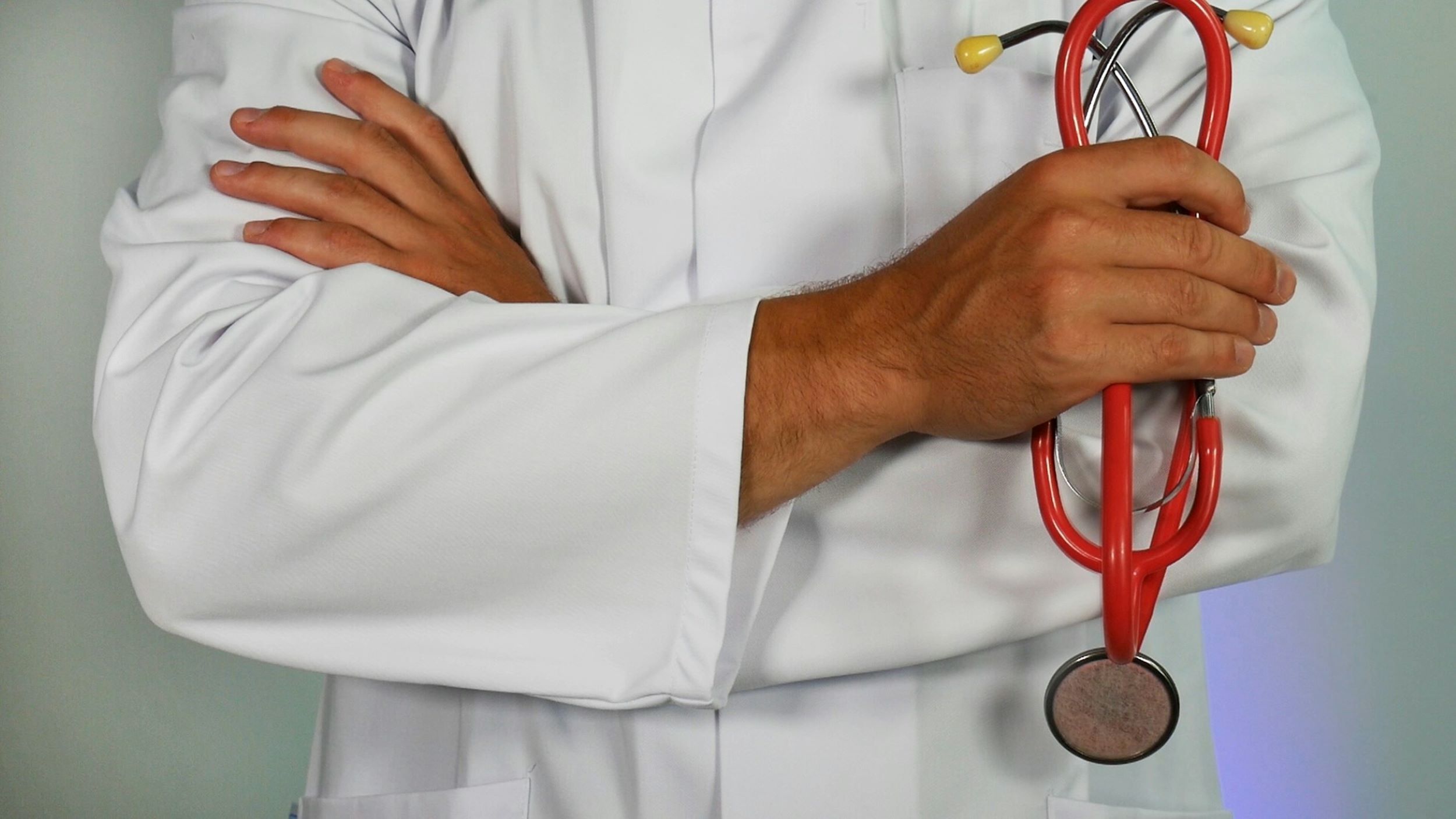 A doctor holds a stethoscope.