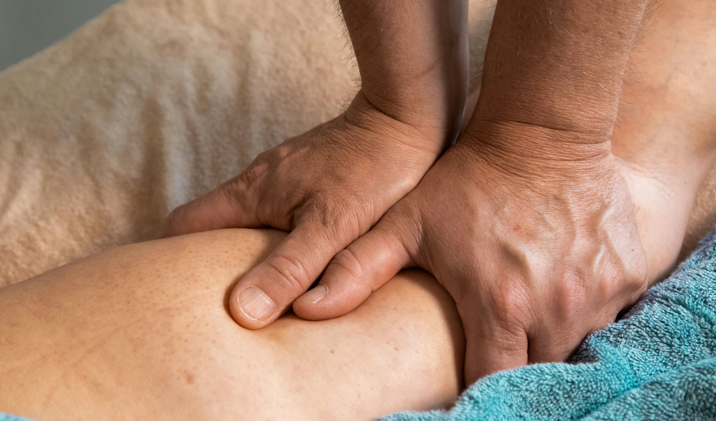 A man massages a patient's arm.