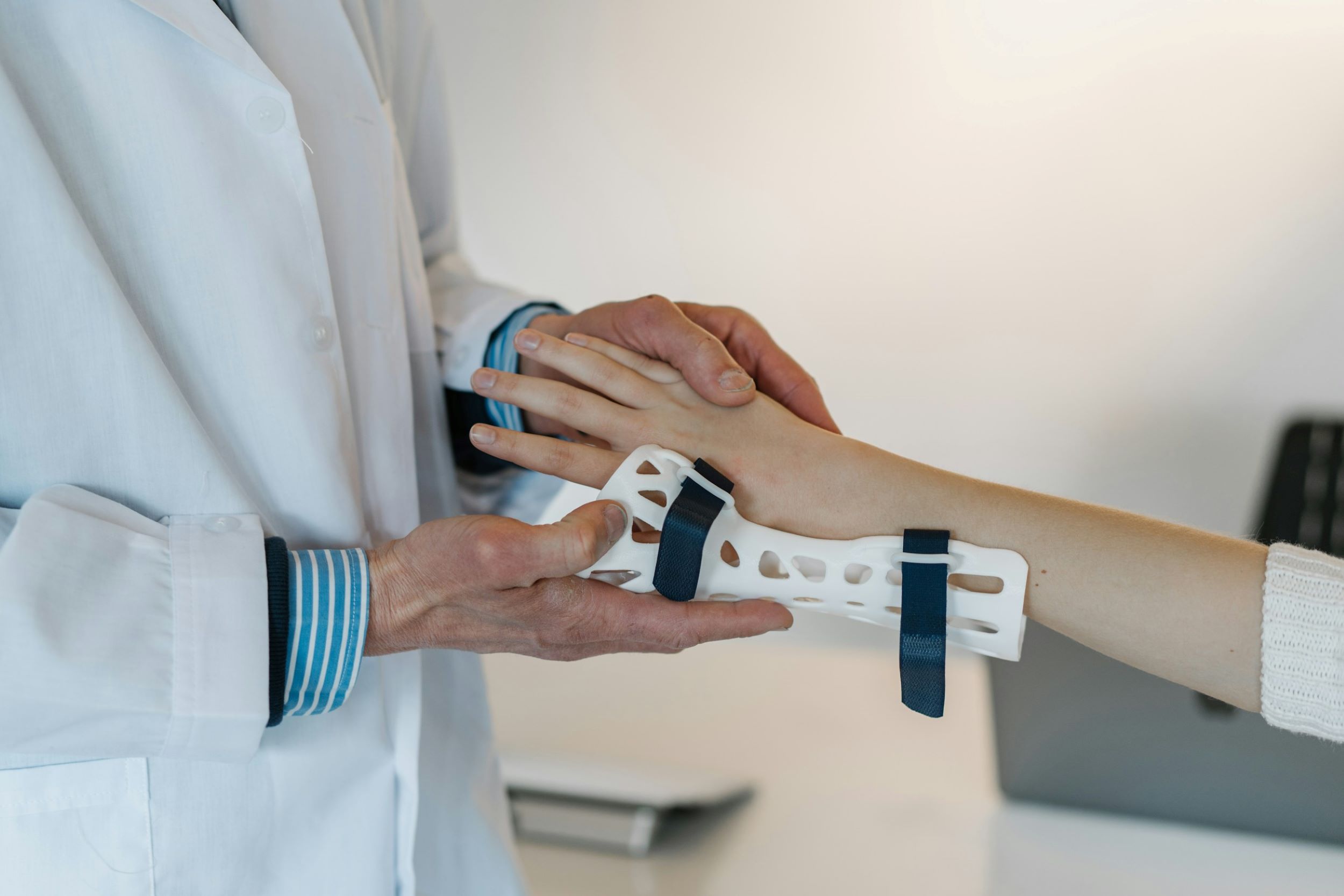 A doctor holds a patient's hand.