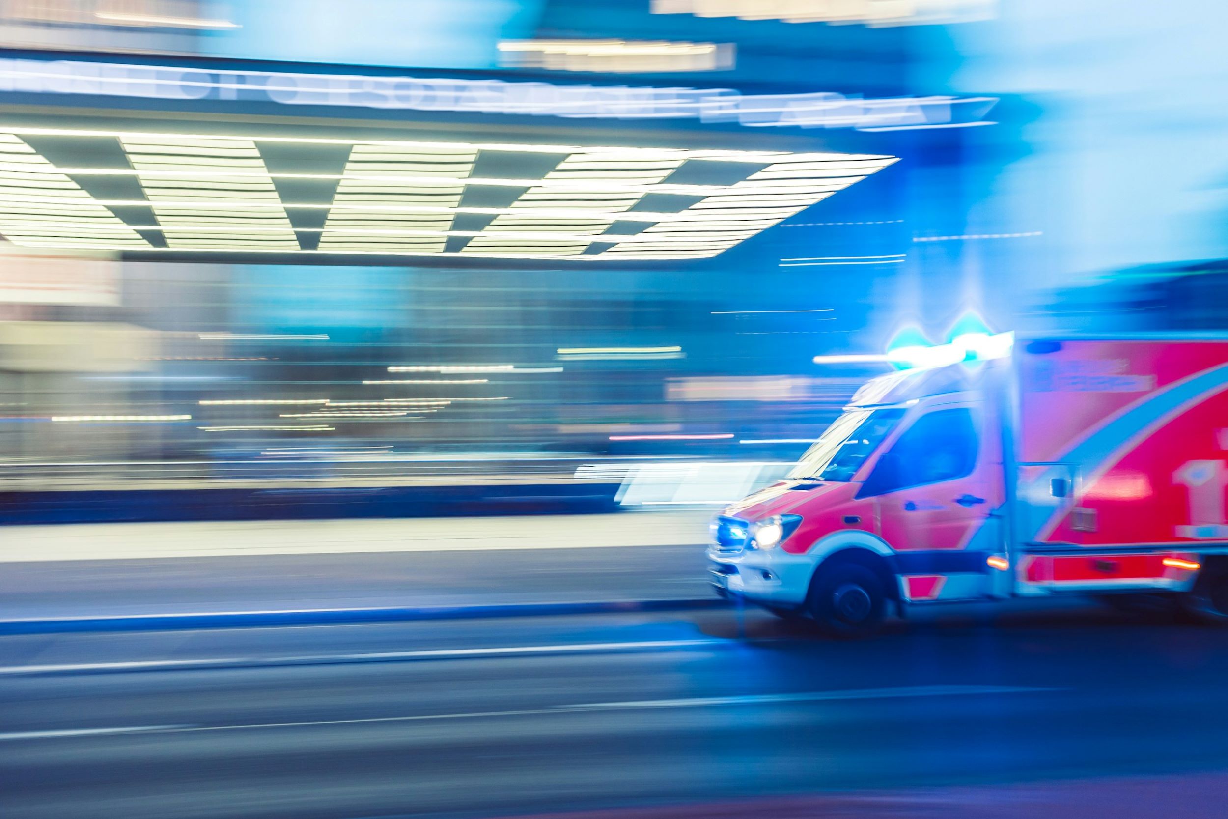An emergency vehicle speeds through the area.