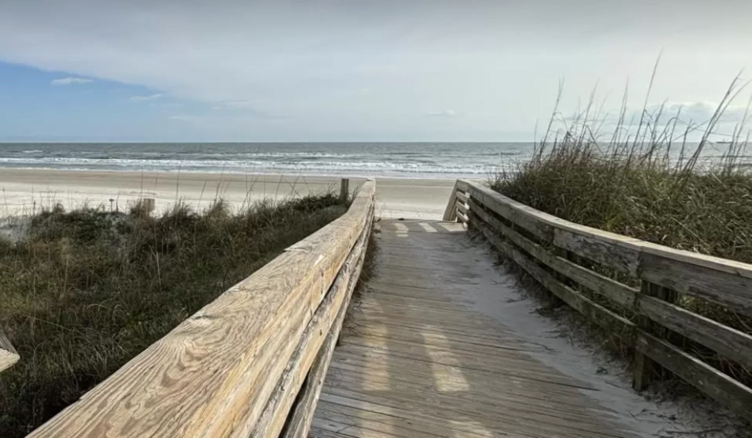 A boardwalk leads to the shores of Crescent Beach.