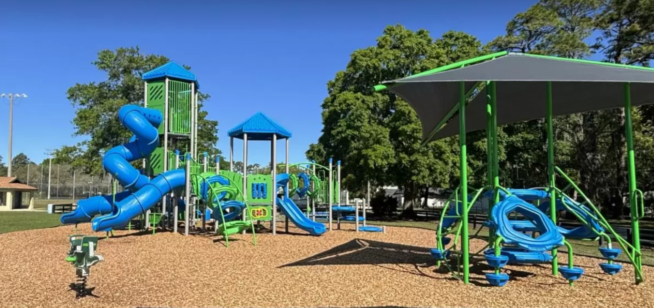 The sun shines brightly over an empty playground.