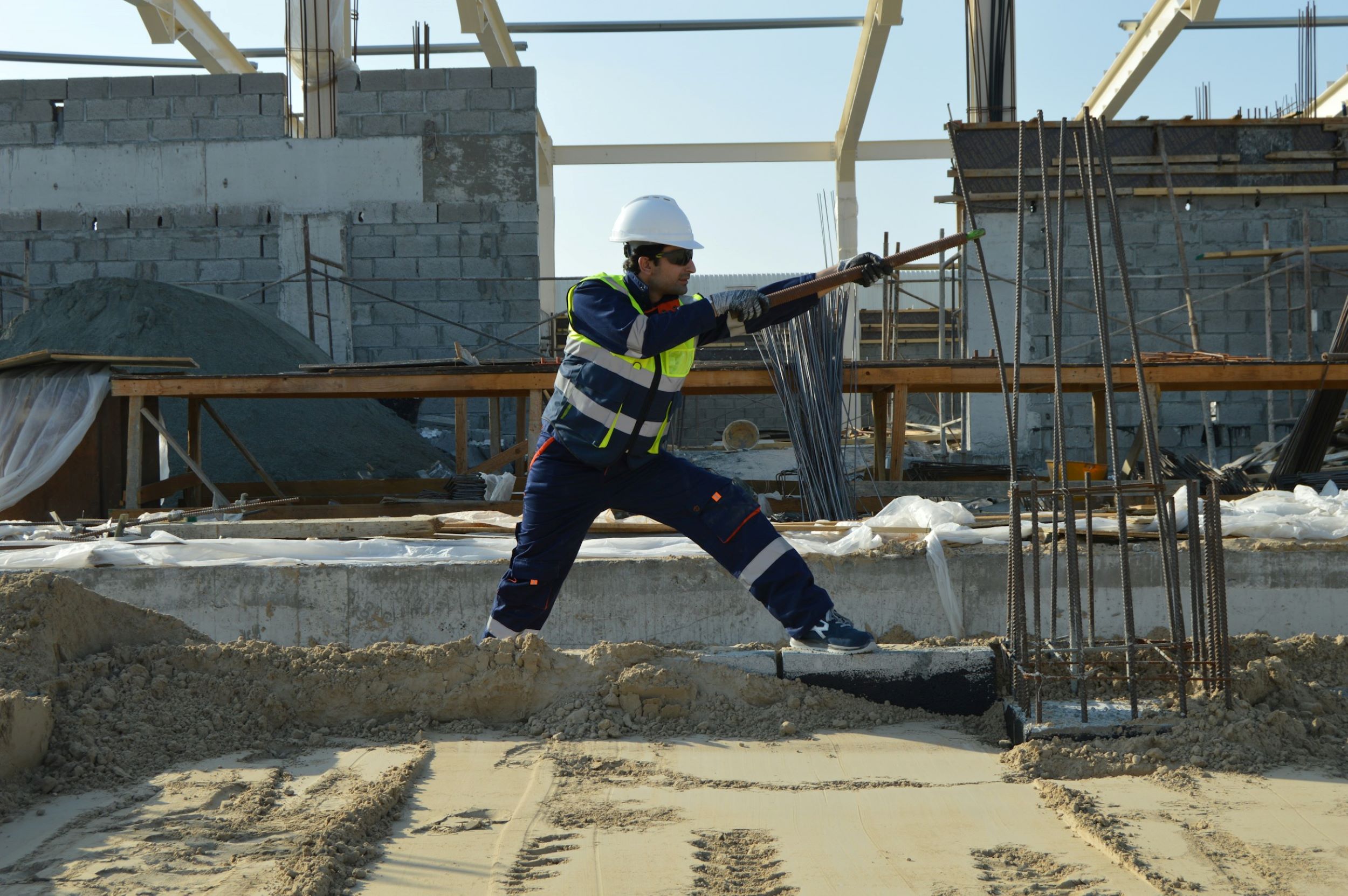 A construction worker finishes a cement floor.