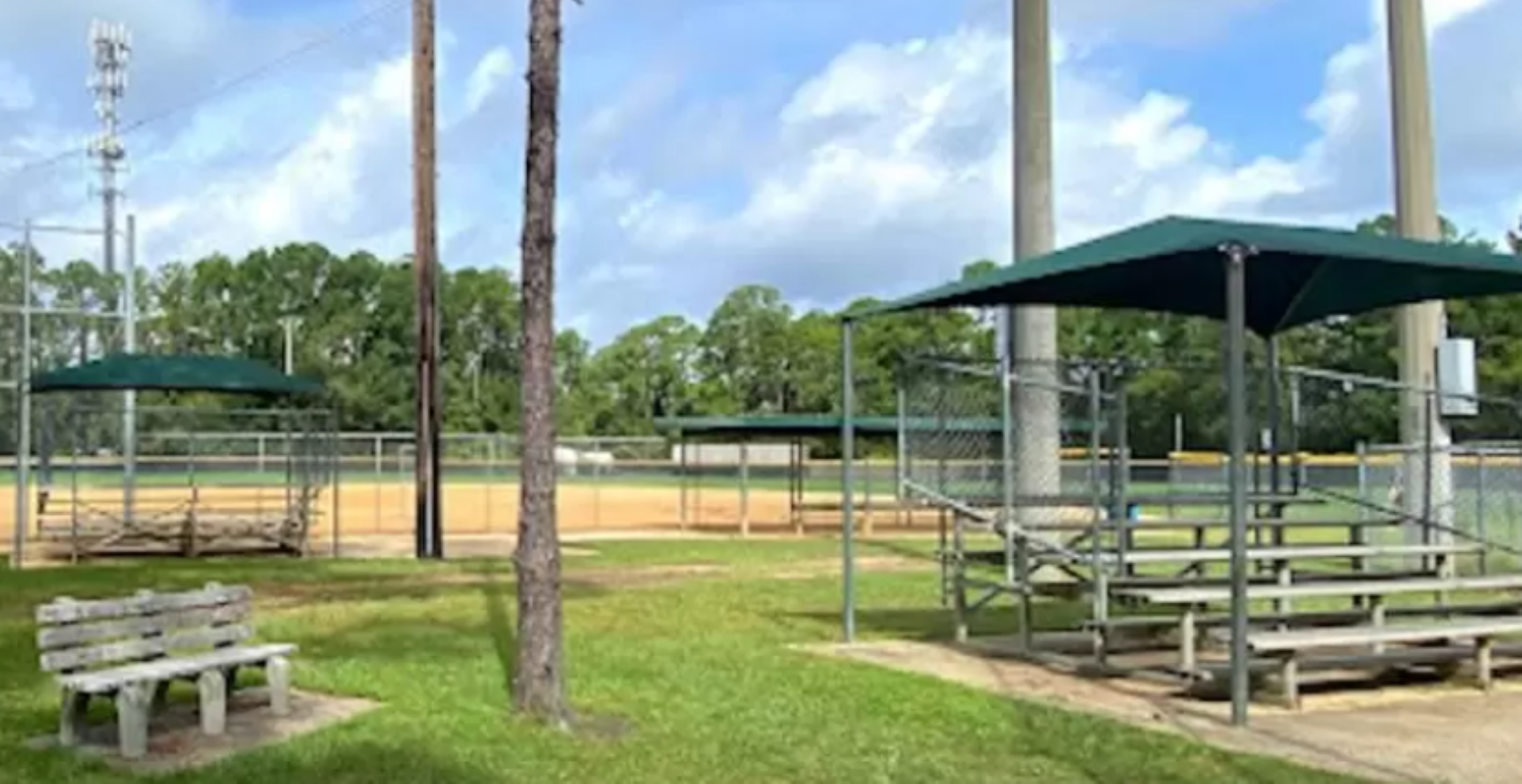 Mill's Field features empty benches and a softball field.