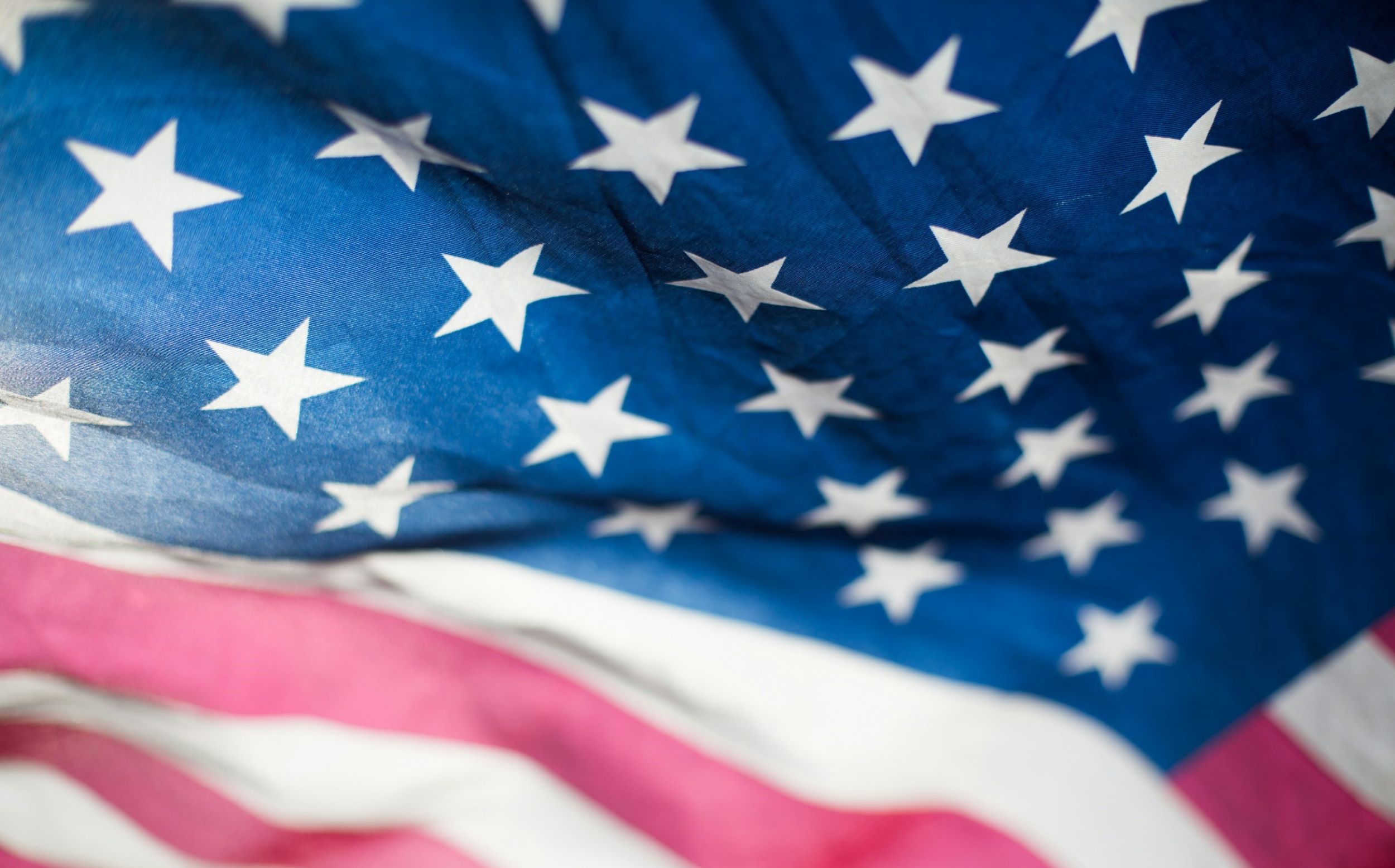 The image features the stars and stripes of the American flag. 
