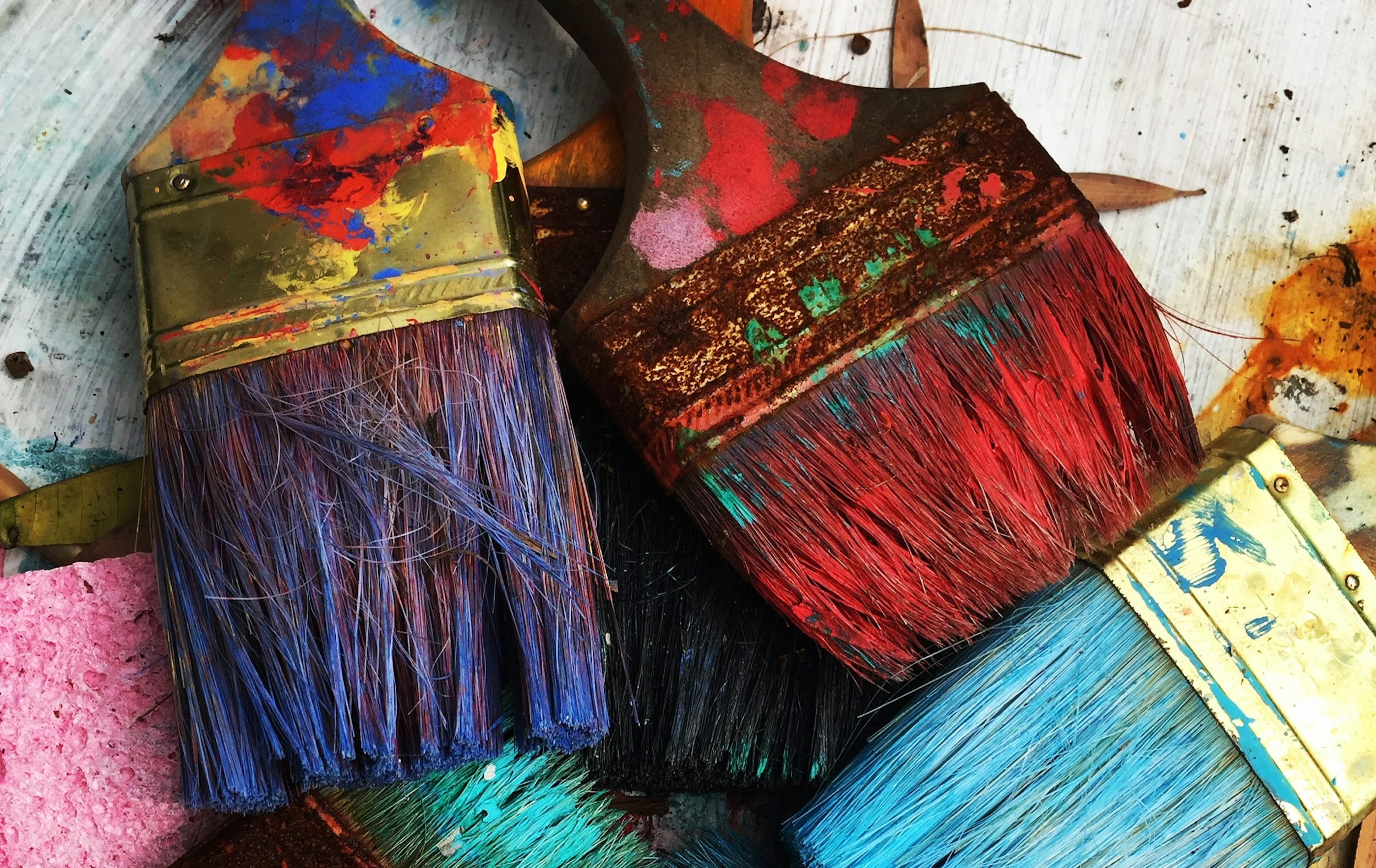Colorful brushes are positioned on a table.