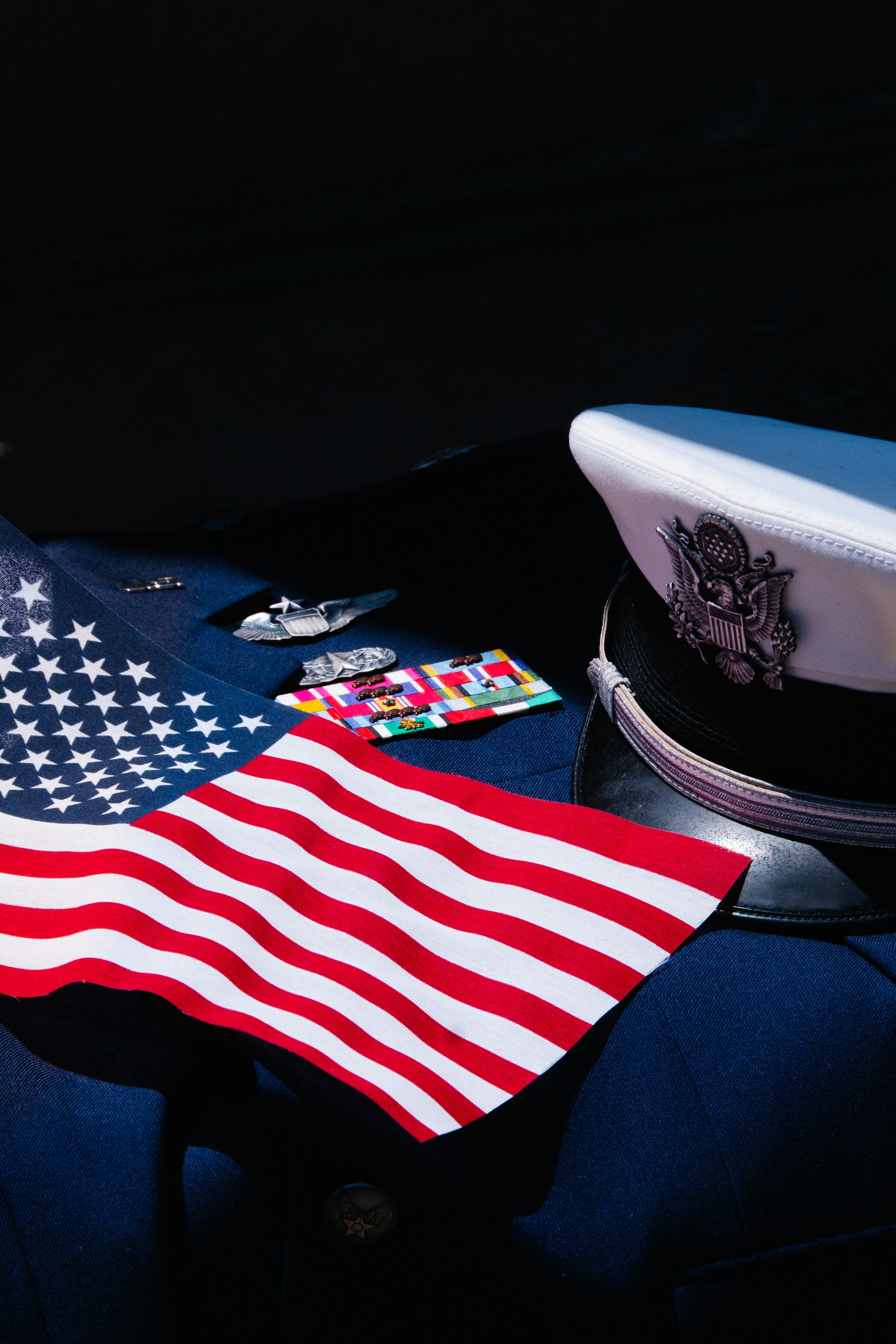 An American flag drapes across a military uniform.