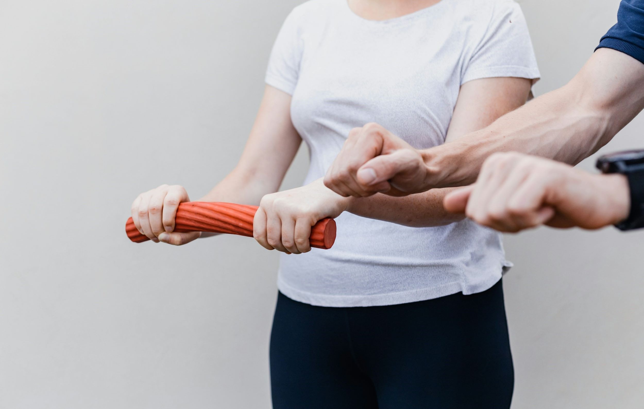A woman engages in a rehabilitation exercise in a therapeutic environment.
