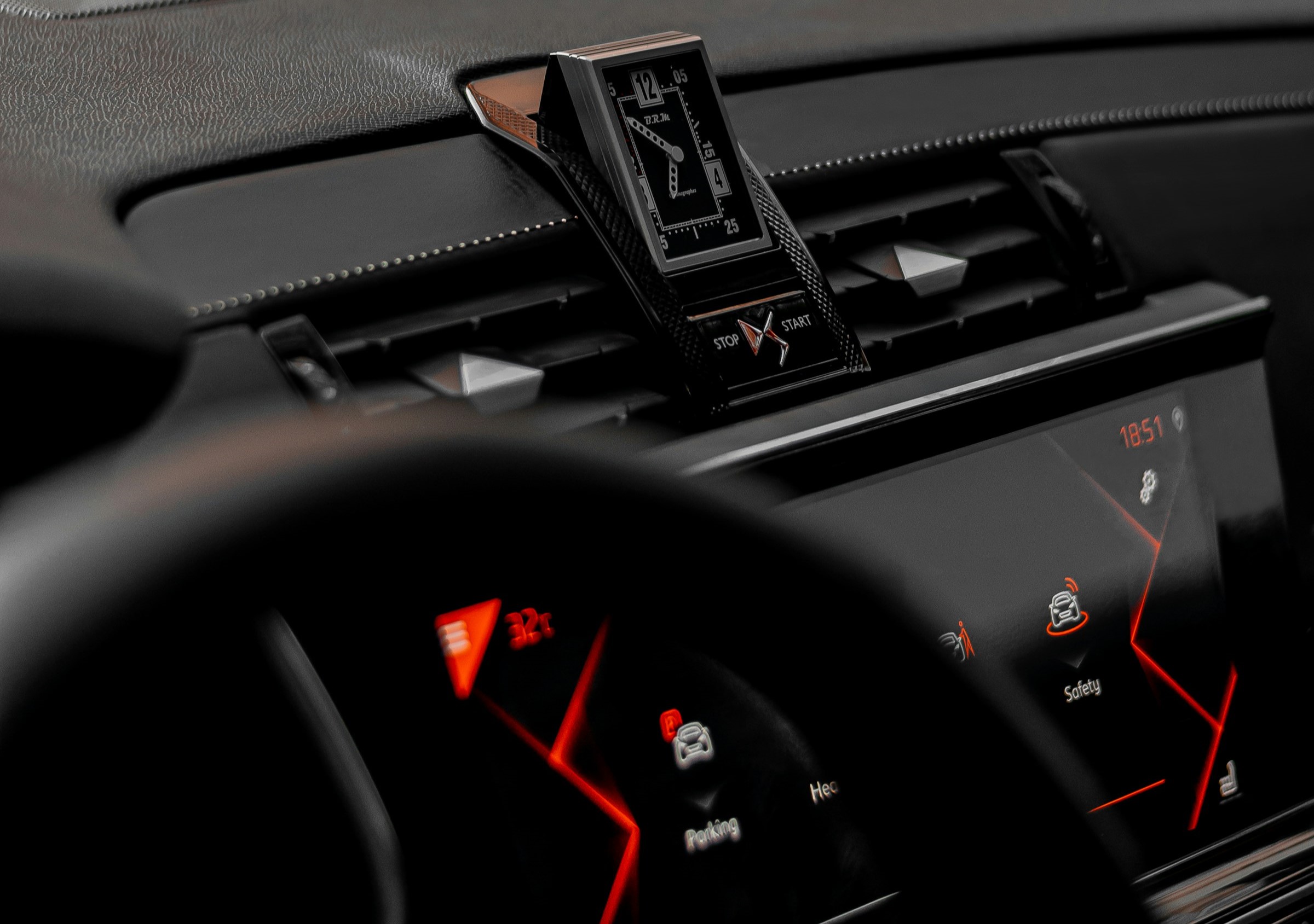 An interior view of a car featuring sleek black accents and a coordinating black steering wheel.