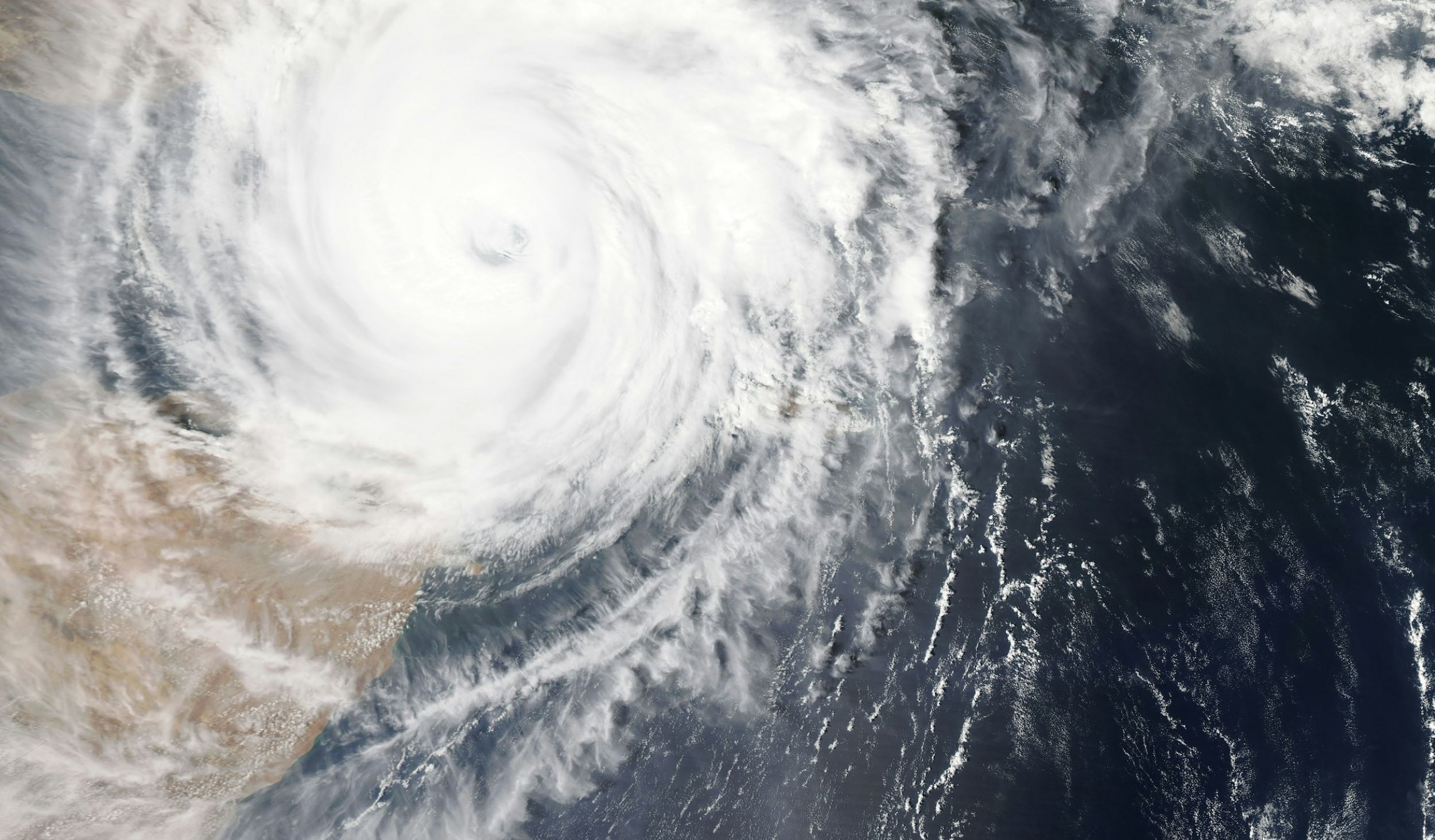 The eye of a storm swirls above earth.