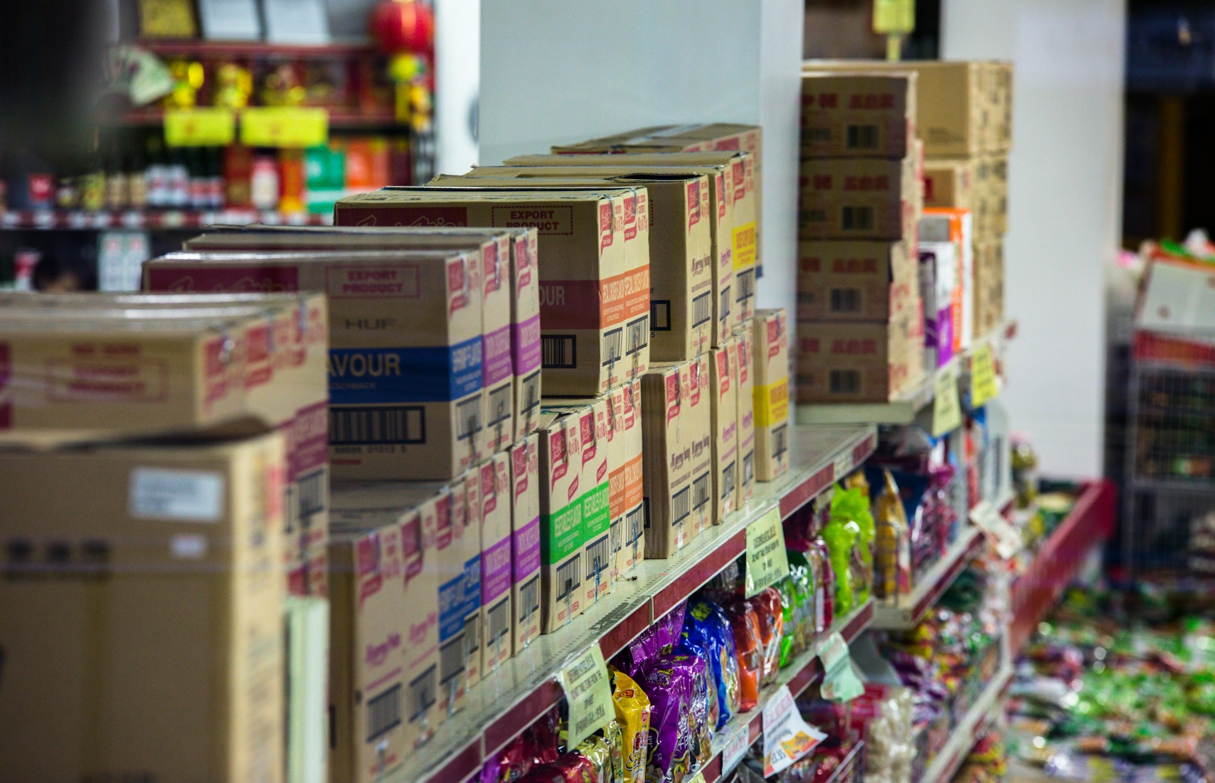 Multiple boxes are neatly arranged and stacked along long shelving units.