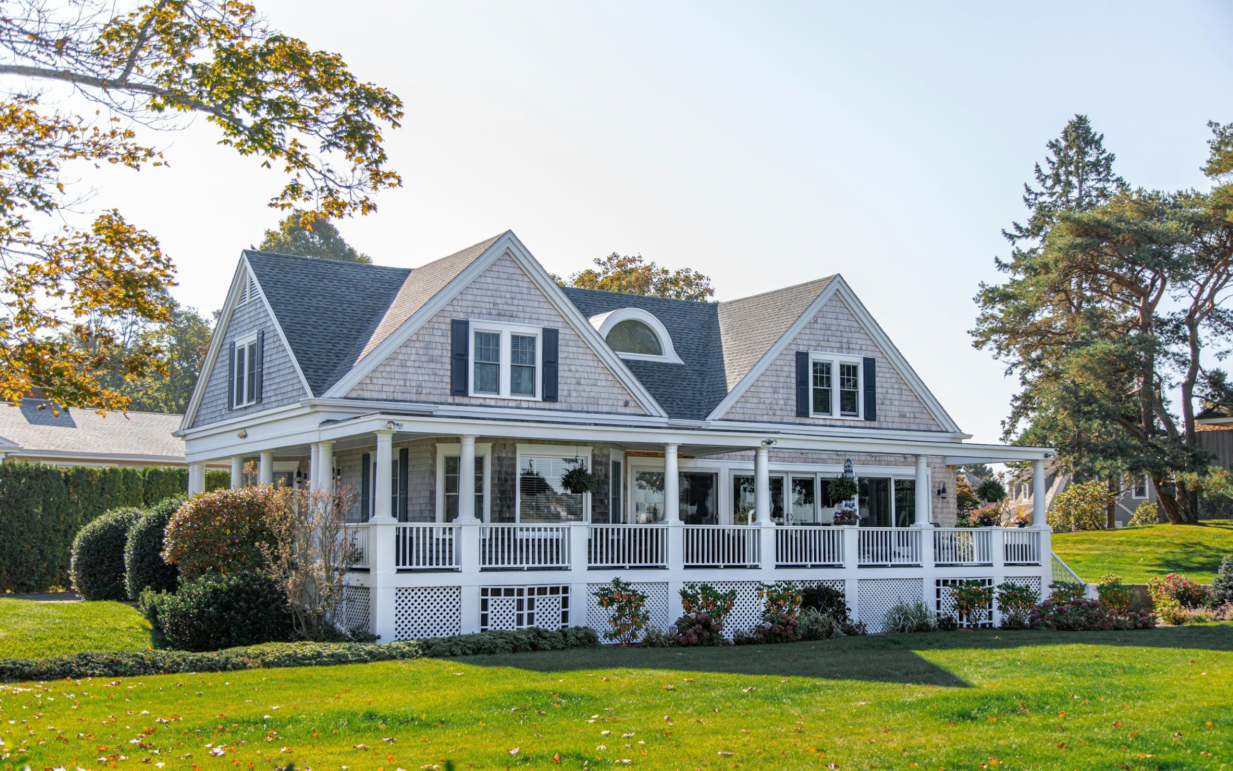 A beautiful home with an enormous deck remains empty on a sunny day. 